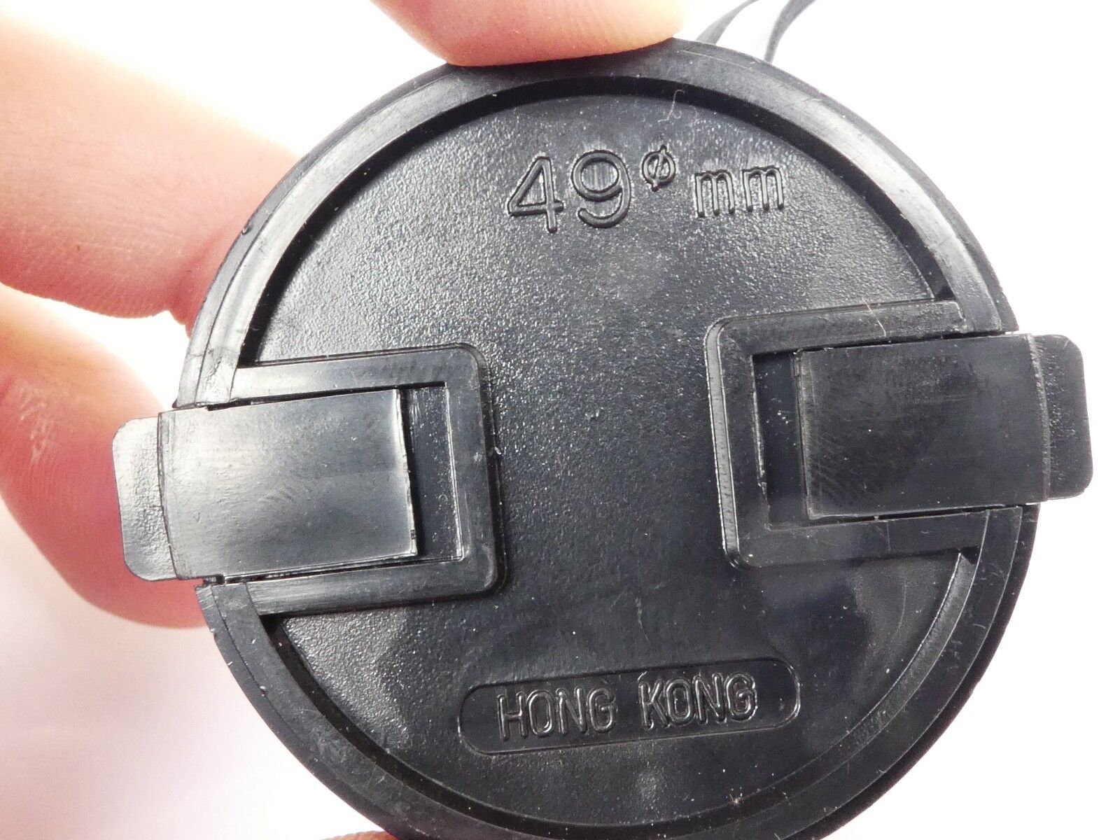 Used 49mm Lens Front Cap Black snap-on type plastic with strap Hong Kong