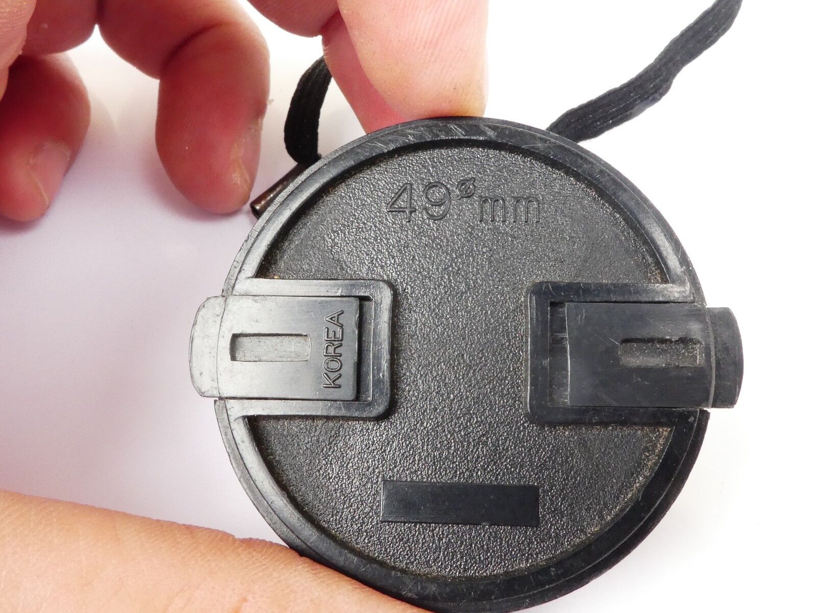 Used 49mm Lens Front Cap Black snap-on type plastic with strap Korea