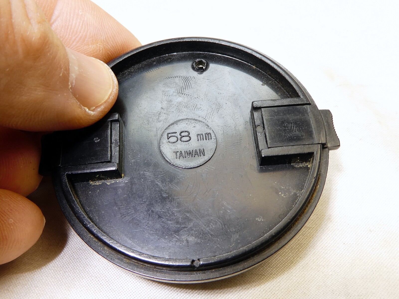 58mm Lens Front Cap made in Taiwan with a hole for the keeper string