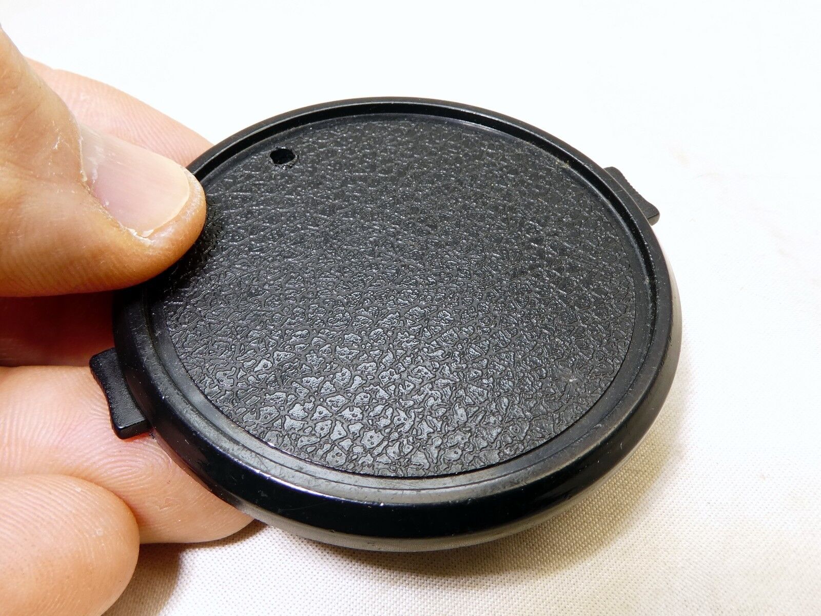 58mm Lens Front Cap made in Taiwan with a hole for the keeper string