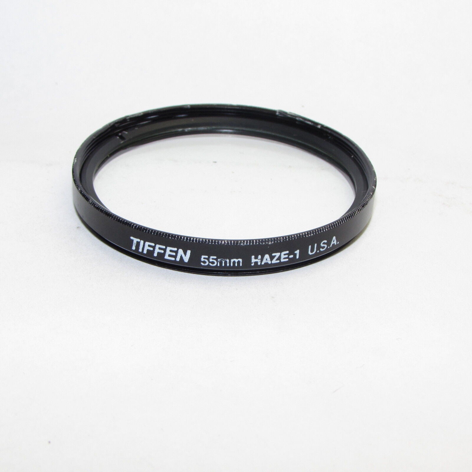 Used Tiffen Haze-1 55mm Lens Filter Made in USA with outer rim bent