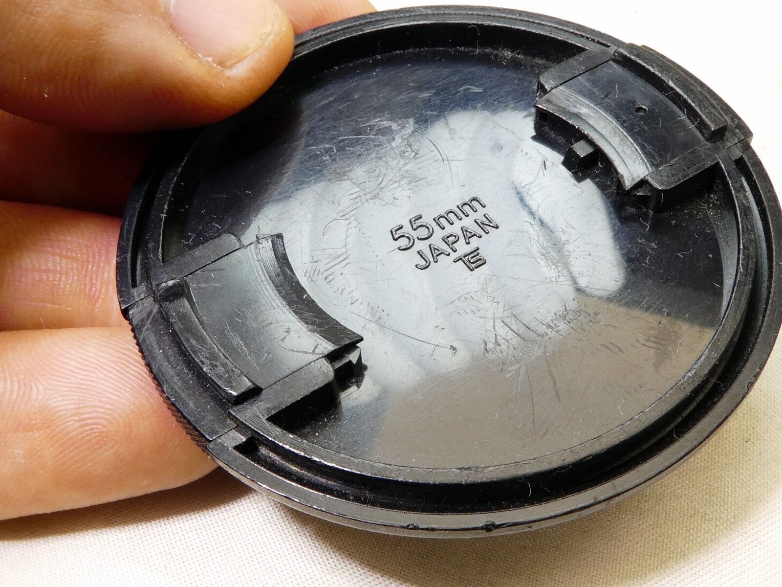 Soligor 55mm Lens front Cap Made in Japan Snap on type      (damaged, but works)