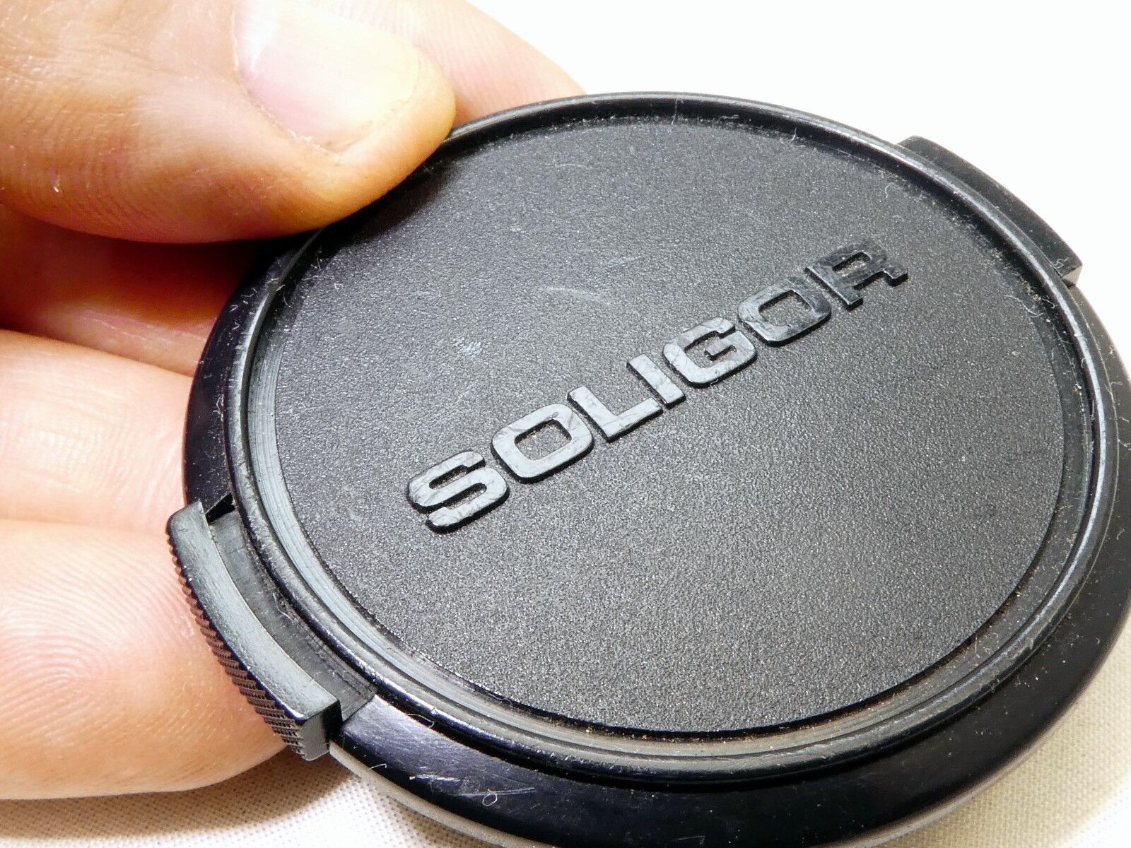 Soligor 55mm Lens front Cap Made in Japan Snap on type      (damaged, but works)