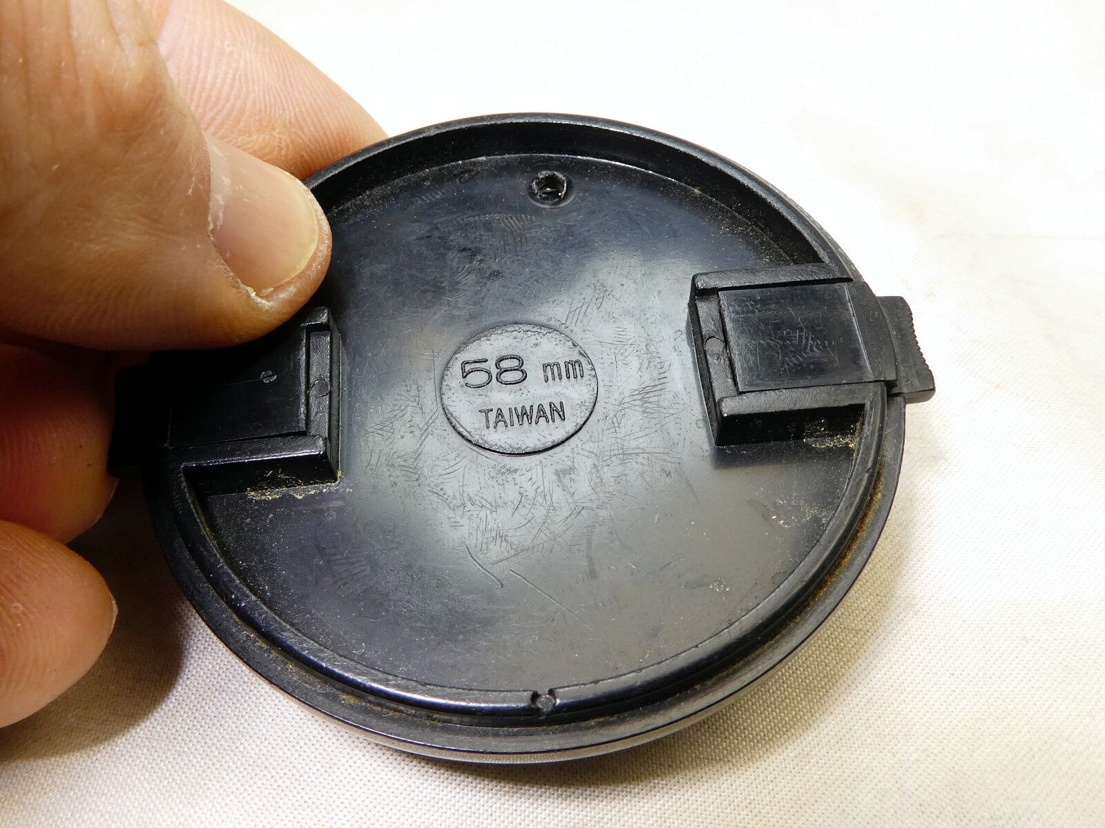 58mm Lens Front Cap made in Taiwan with a hole for the keeper string