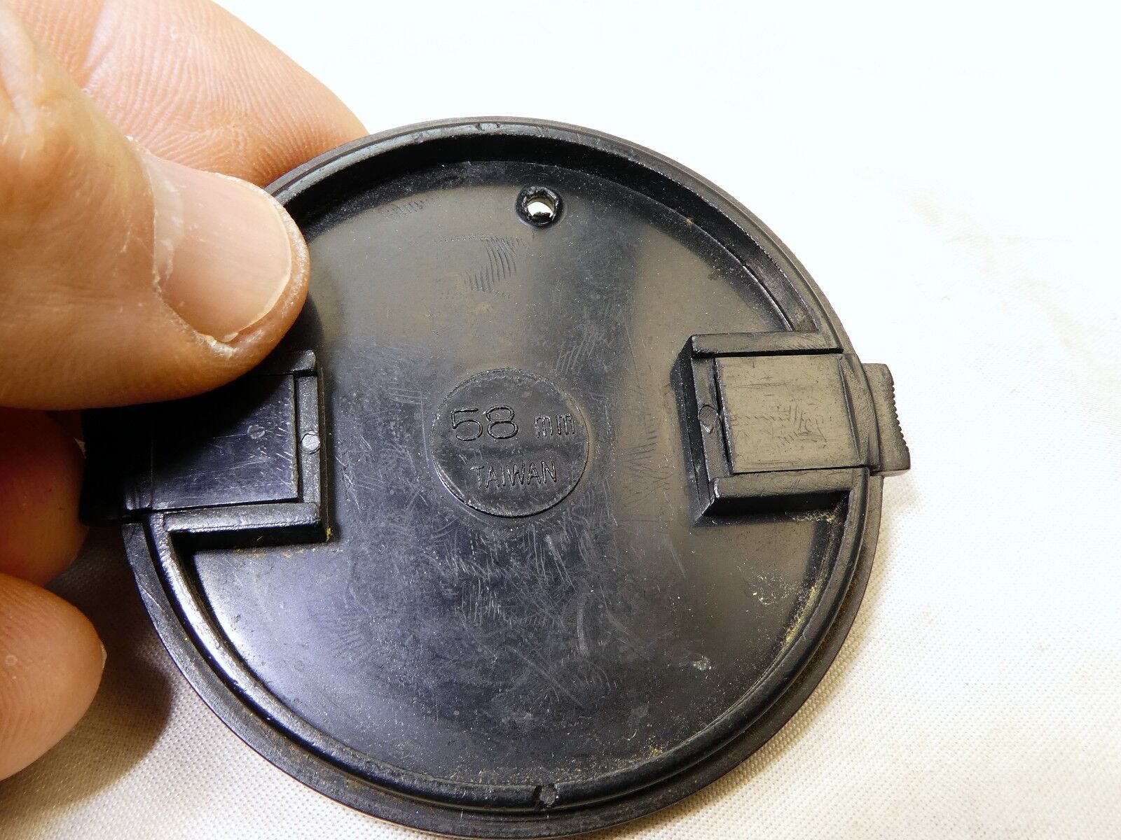 58mm Lens Front Cap made in Taiwan with a hole for the keeper string