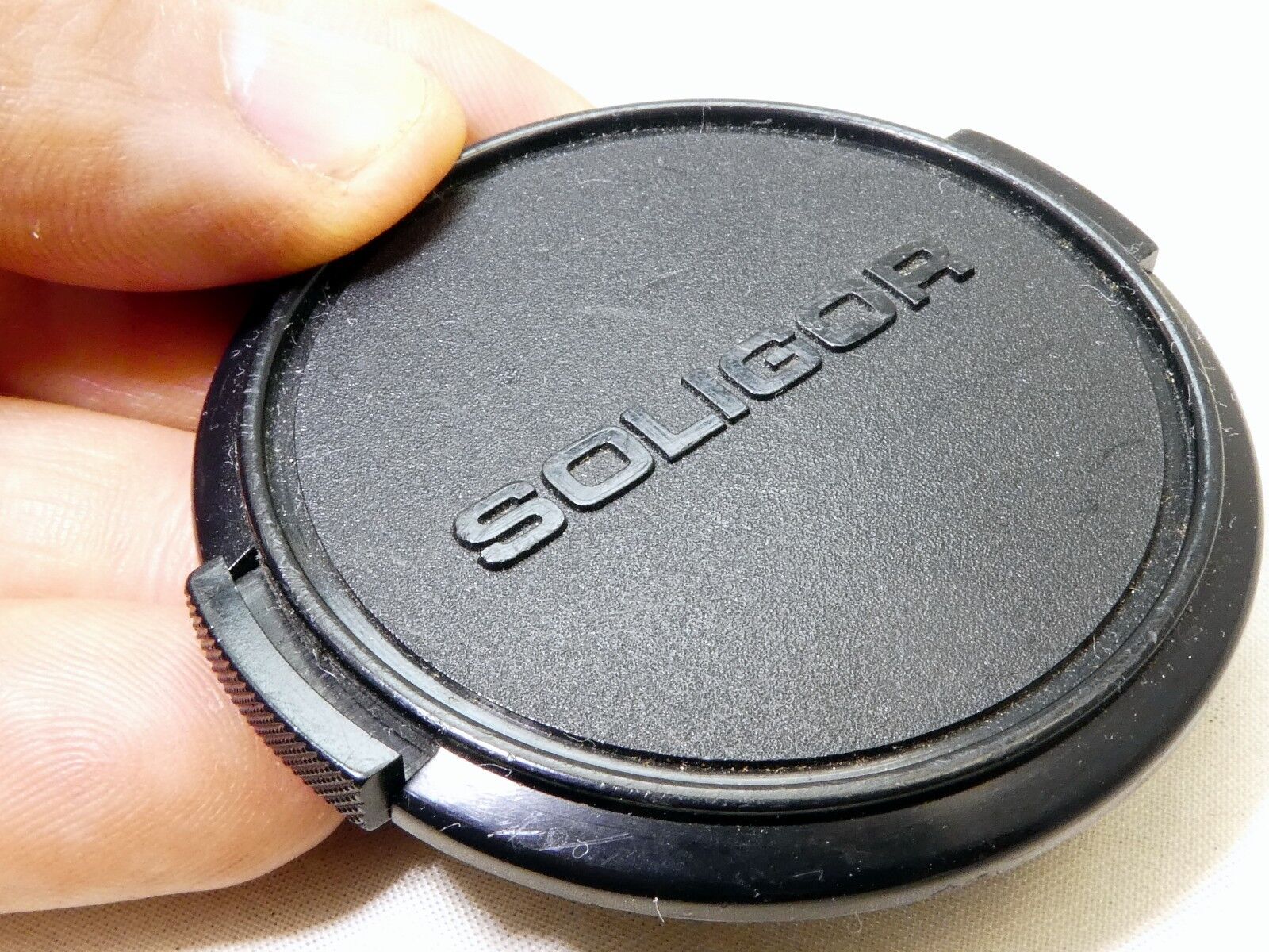 Soligor 55mm Lens front Cap Made in Japan Snap on type      (damaged, but works)